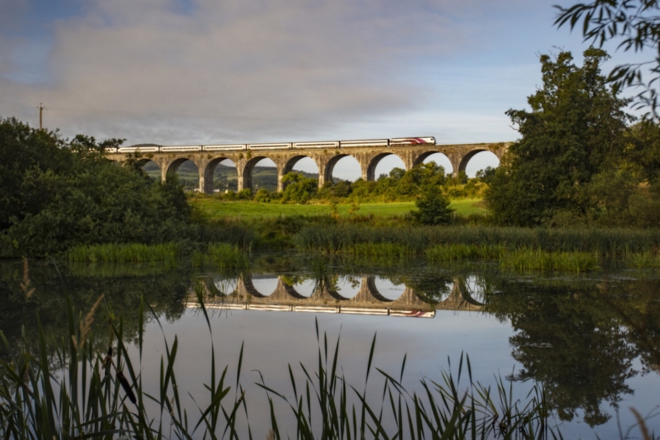 Dublin - Belfast "Enterprise" train crossing a viaduct with a lake in the foreground