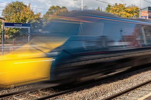 Train at speed through Leyland station in UK (Image RIA)