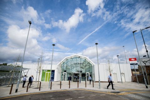 A blue sky over an artistic impression of the concourse at the redeveloped Motherwell station - showing a huge barrelled glass atrium and white walls on either side