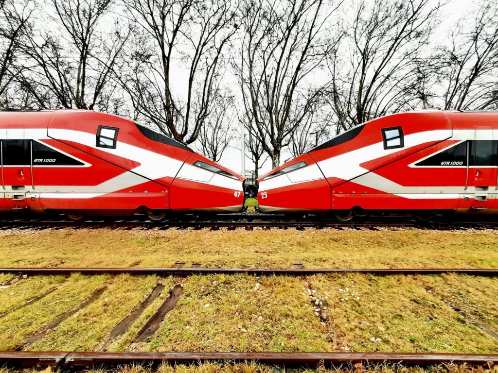 Two of Trenitalia's Red Arrows share a kiss.