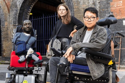 Disability campaigner Caroline Stickland with two disable passengers outside a station in England