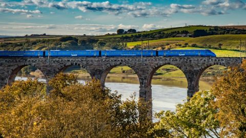 Lumo train UK on bridge