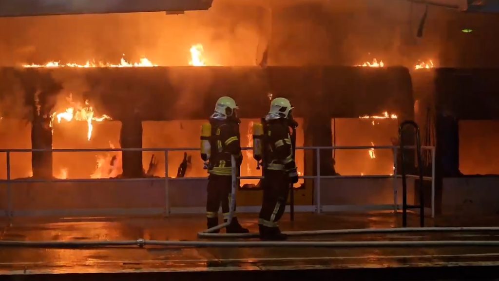 Firefighters extinguish a burning train at the Ahrensfelde commuter train station in Berlin.